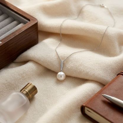 Pearl And Diamond Bale Pendant In 14k White Gold 1/12ctw — textile flat lay
