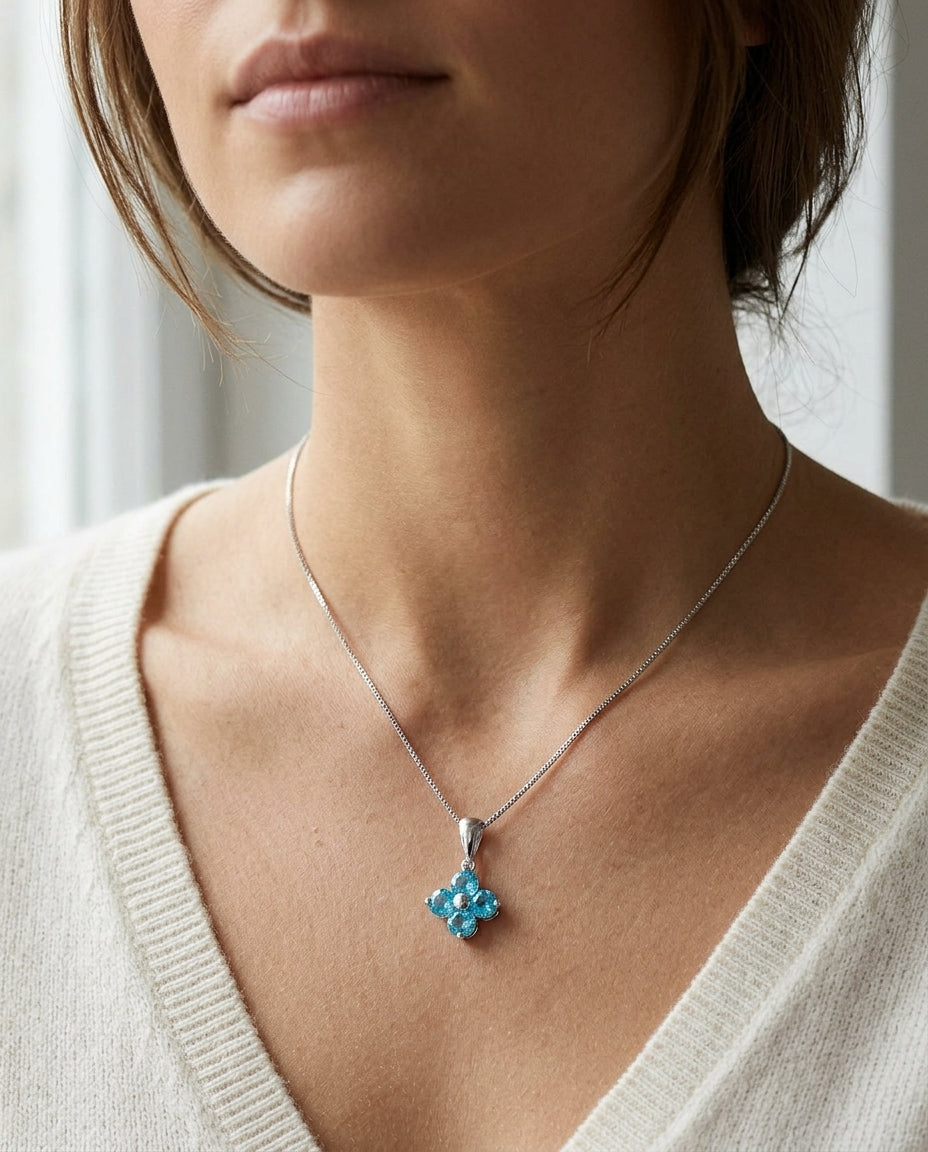 Blue Topaz Floral Pendant In 14k White Gold — editorial close-up