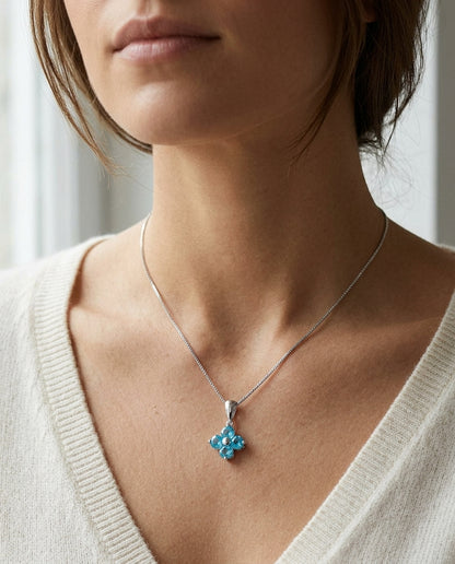 Blue Topaz Floral Pendant In 14k White Gold — editorial close-up