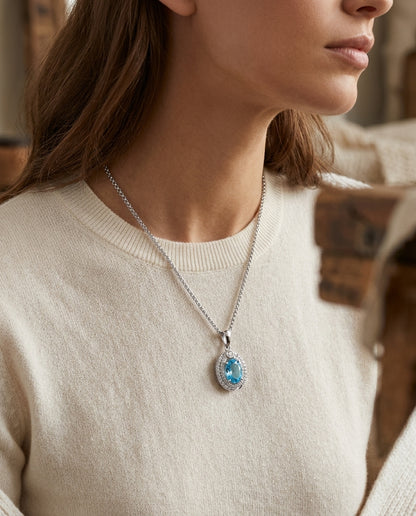 Oval Swiss Blue Topaz & Diamond Pendant In 14k White Gold — editorial close-up