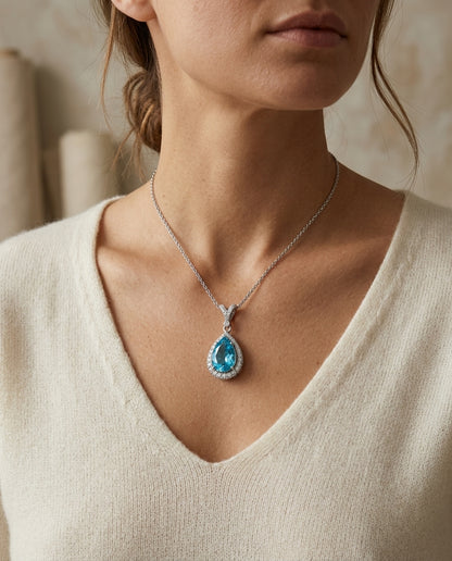 Blue Topaz And Diamond Pear-shape Halo Pendant With Split Bail In 14k White Gold — editorial close-up