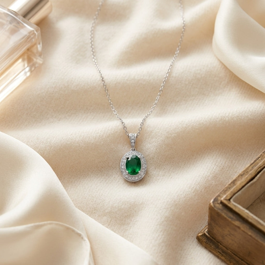 Emerald And Diamond Oval Halo Pendant In 14k White Gold 16 In Rolo Chain — textile flat lay