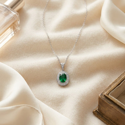Emerald And Diamond Oval Halo Pendant In 14k White Gold 16 In Rolo Chain — textile flat lay