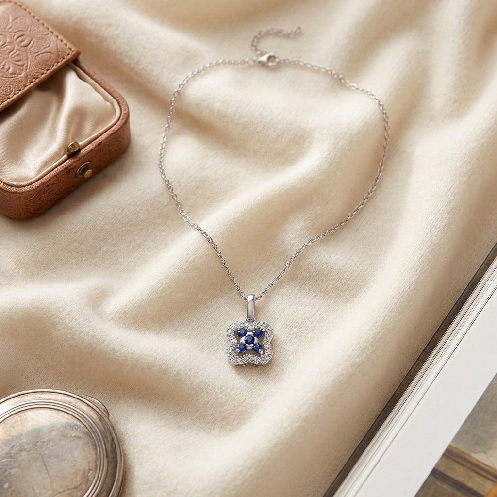 Sapphire and Diamond Floral Petal Pendant in 14k White Gold — textile flat lay