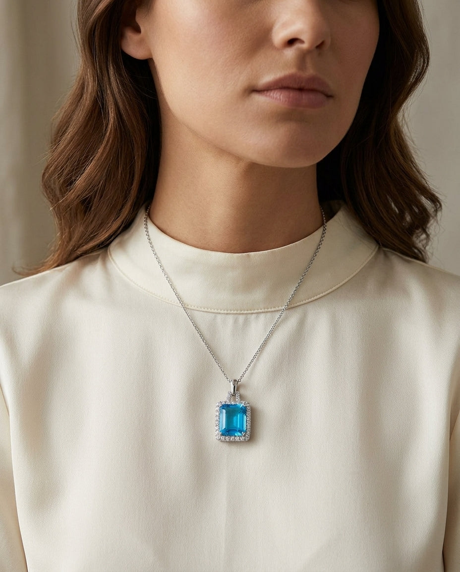 Swiss Blue Topaz And Diamond Halo Pendant With Trapezoid Bail In 14k White Gold — editorial close-up