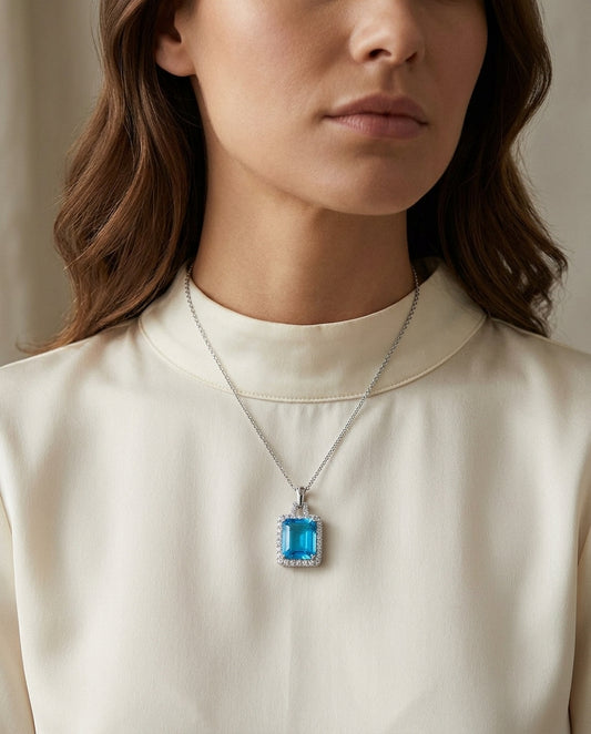 Swiss Blue Topaz And Diamond Halo Pendant With Trapezoid Bail In 14k White Gold — editorial close-up