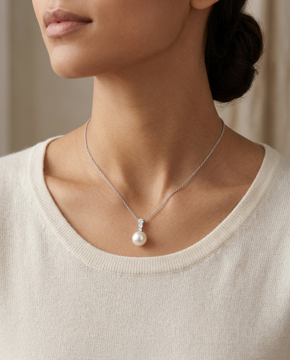 White Cultured Akoya Pearl And Diamond Pendant In 14k White Gold — editorial close-up