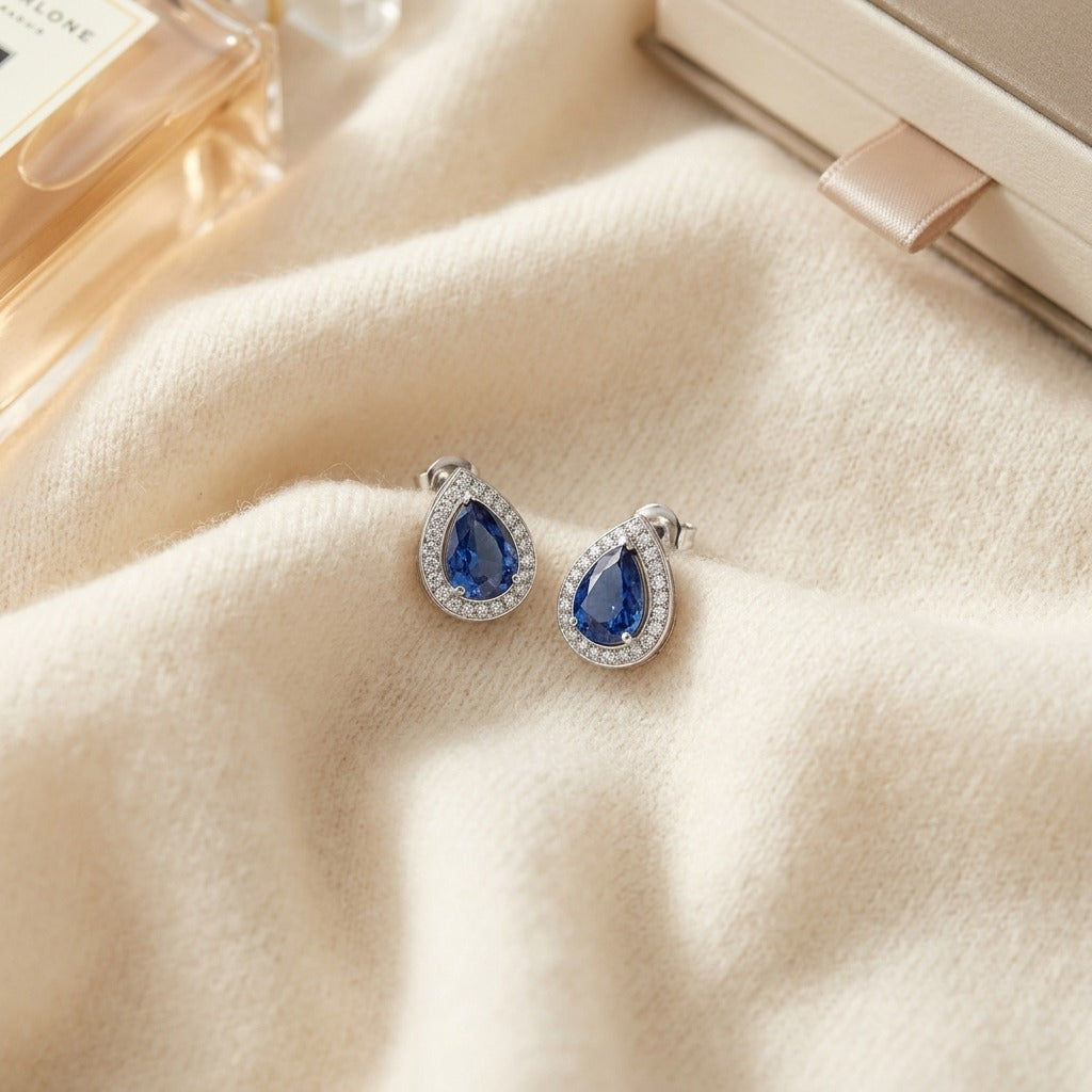Sapphire and Diamond Teardrop Halo Pendant with Studded Bail in 14k White Gold (8x6mm) — textile flat lay