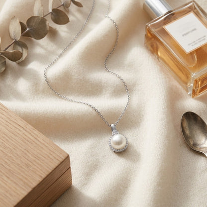 Fresh Water Pearl And Diamond Halo Pendnat In 14k White Gold — textile flat lay