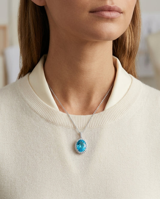 Blue Topaz And Diamond Oval Halo Pendant In 14k White Gold (10x8mm) (hi / Si ) — editorial close-up