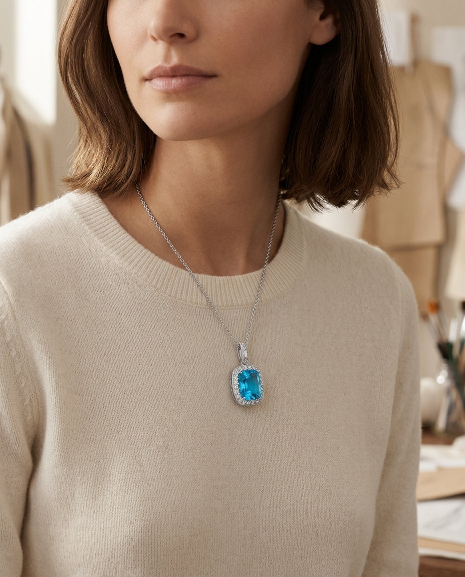 Blue Topaz And Diamond Elongated Cushion Halo Pendant In 14k White Gold — editorial close-up