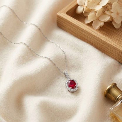 Ruby Oval and Diamond Halo Pendant in 14k White Gold — textile flat lay