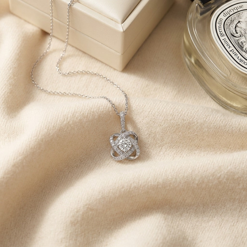 Diamond Pave Cross Knot Pendant with Round Center in 14k White Gold — textile flat lay