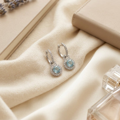 Aquamarine And Diamond Door Knocker Dangle Earrings in 14k White Gold — textile flat lay