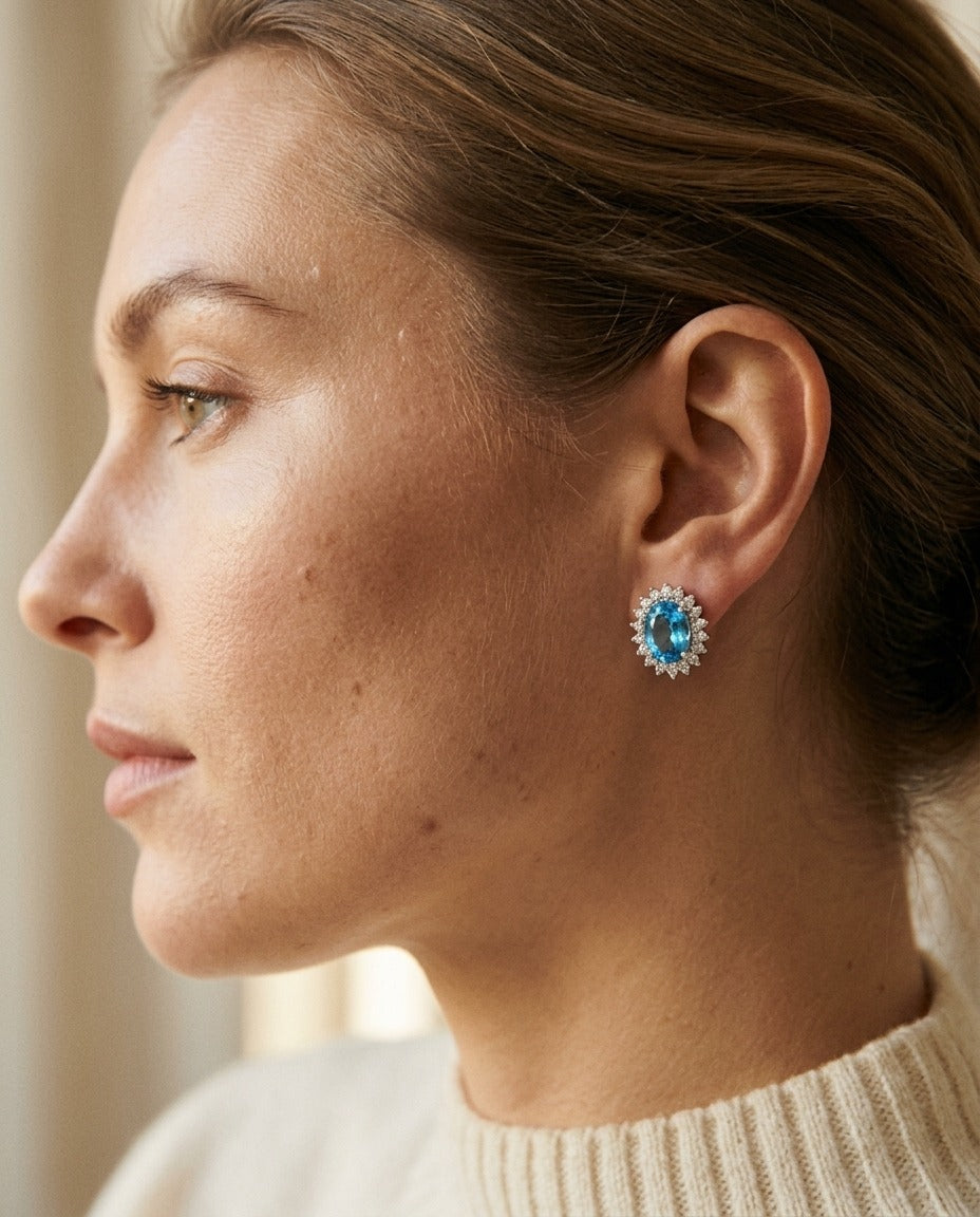 Blue Topaz And Diamond Prong Oval Halo Stud Earrings in 14k White Gold — portrait close