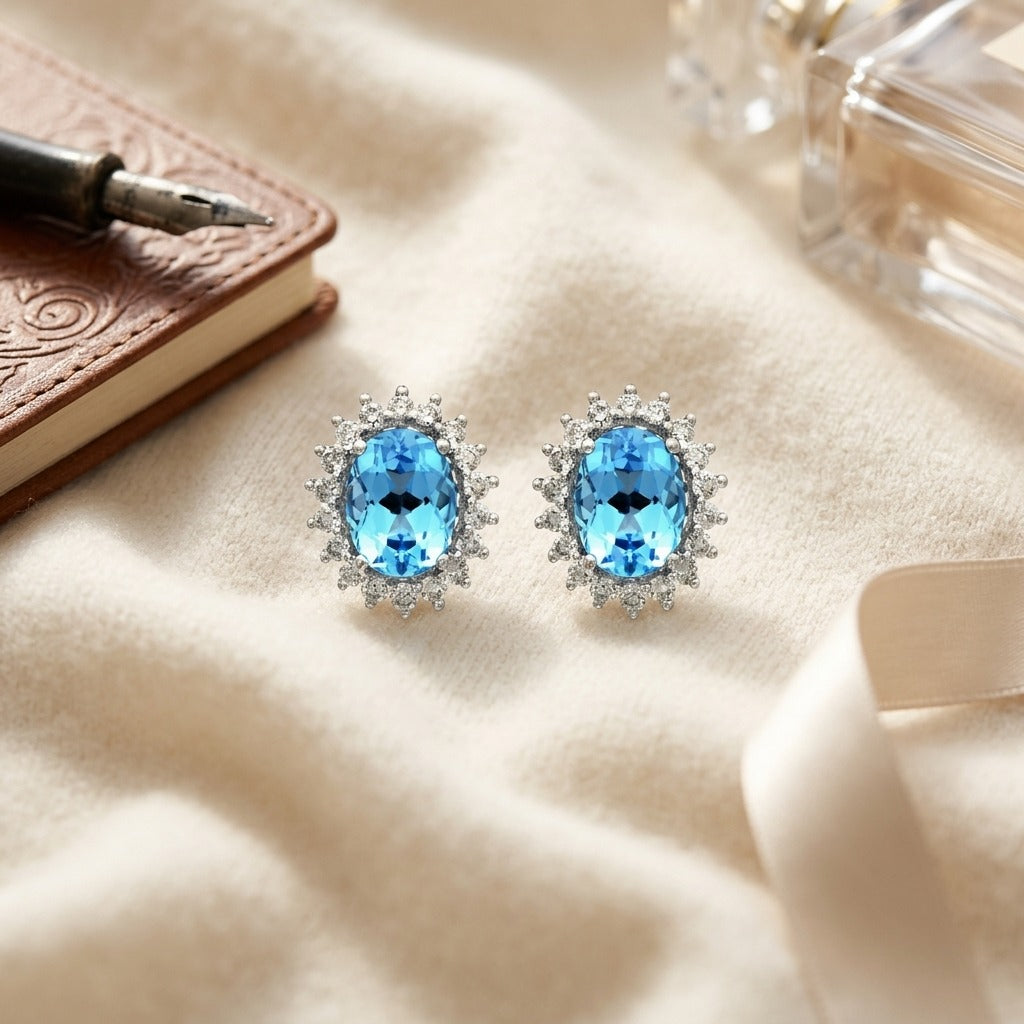 Blue Topaz And Diamond Prong Oval Halo Stud Earrings in 14k White Gold — textile flat lay
