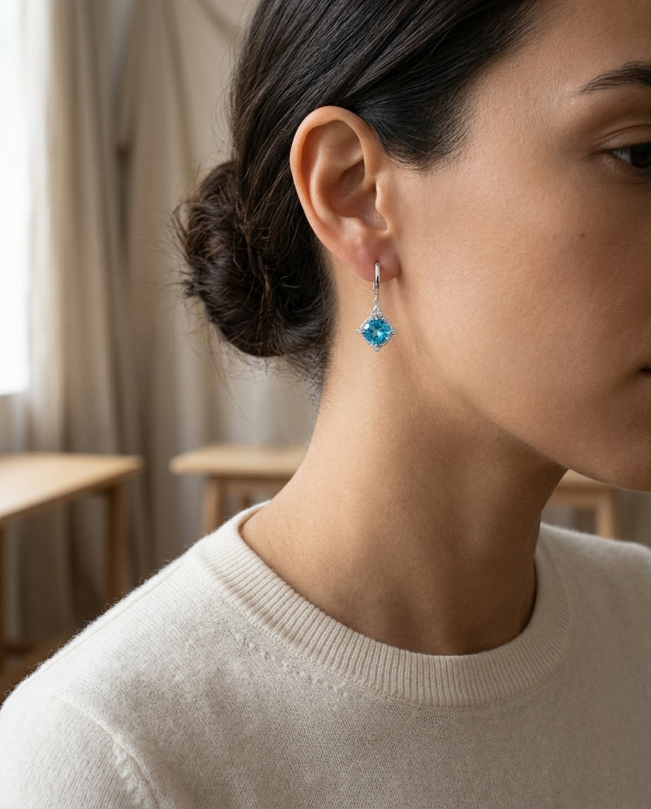 Blue Topaz Cushion Dangle Earrings In 14k White Gold — editorial close-up