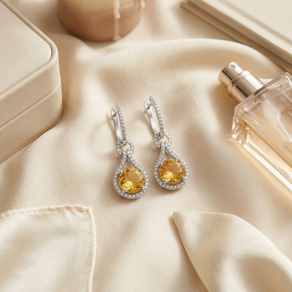 Citrine And Diamond Round Doorknocker Earrings In 14k White Gold (8mm) — textile flat lay
