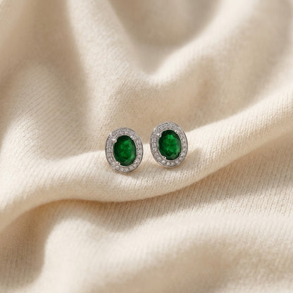 Emerald Oval And Diamond Earrings In 14k White Gold (8x6mm) — textile flat lay