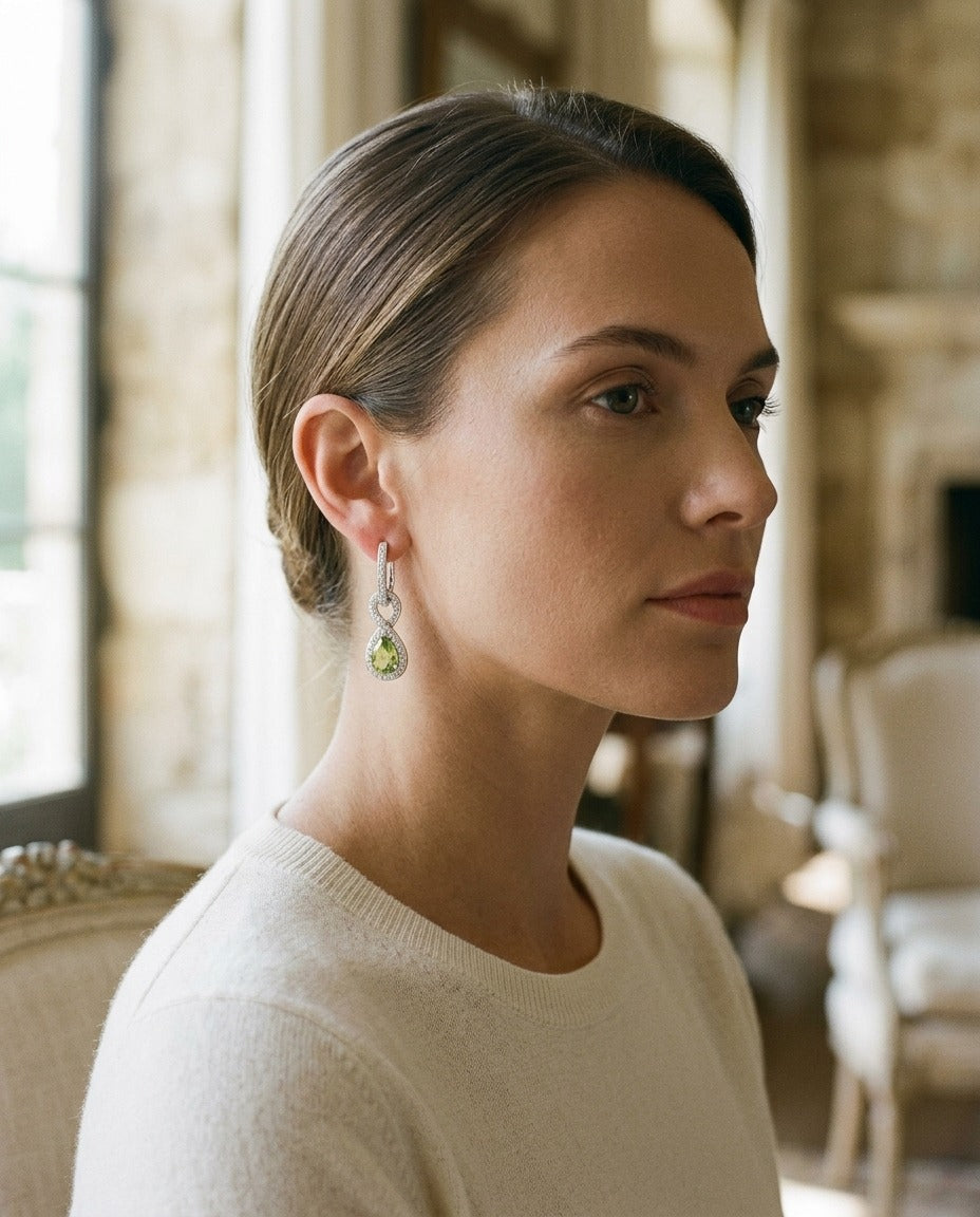 Peridot And Diamond Infinity Dangle Earrings In 14k White Gold — portrait close