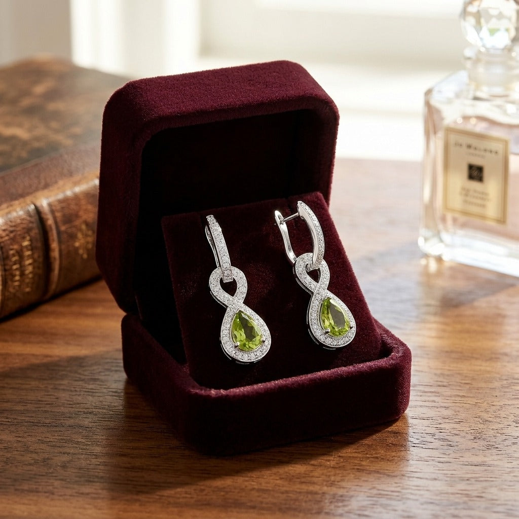 Peridot And Diamond Infinity Dangle Earrings In 14k White Gold — velvet box