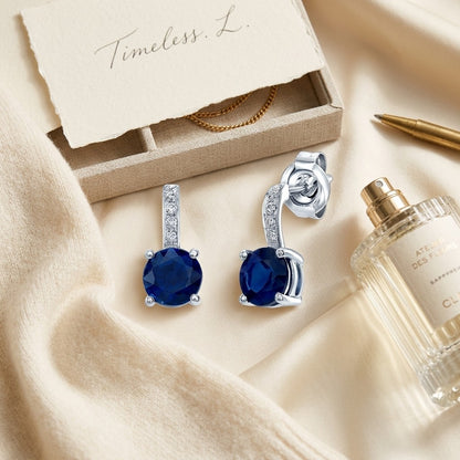 Sapphire And Diamond Earrings In 14k White Gold — textile flat lay