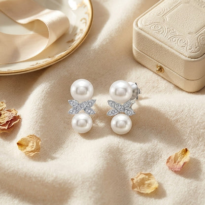 Freshwater Pearl And Diamond Butterfly Earring In 14k White Gold — textile flat lay