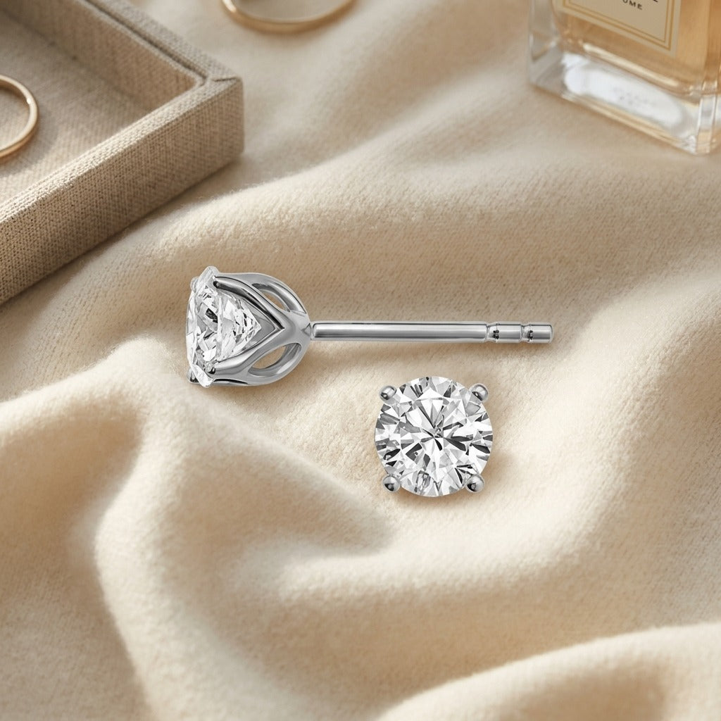 Diamond Round 4-prong Tulip Basket Stud Earrings In 14k White Gold (1.25ctw) — textile flat lay