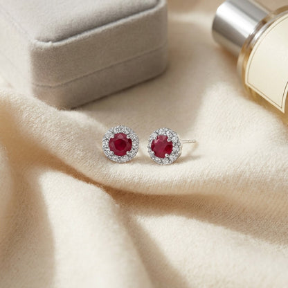 Ruby and Diamond Halo Earrings in 14k White Gold — textile flat lay