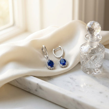 Sapphire Oval and Diamond Starburst Frame Earrings in 14k White Gold (7x5mm) — marble silk