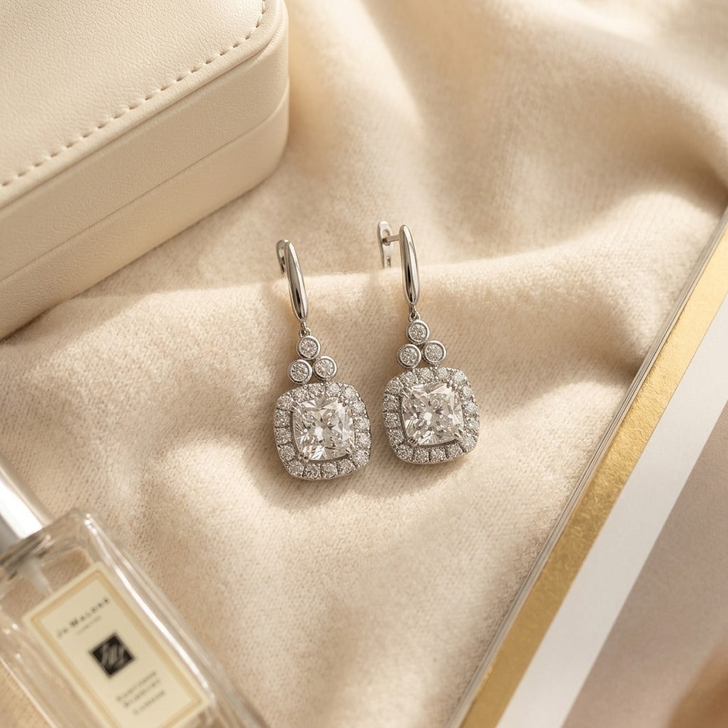 Tanzanite and Diamond Cushion Halo Earrings in 14k White Gold 1/3ctw — textile flat lay