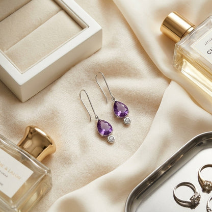 Amethyst and Bezel Diamond Teardrop Leverback Earrings in 14k White Gold 1/8ctw — textile flat lay