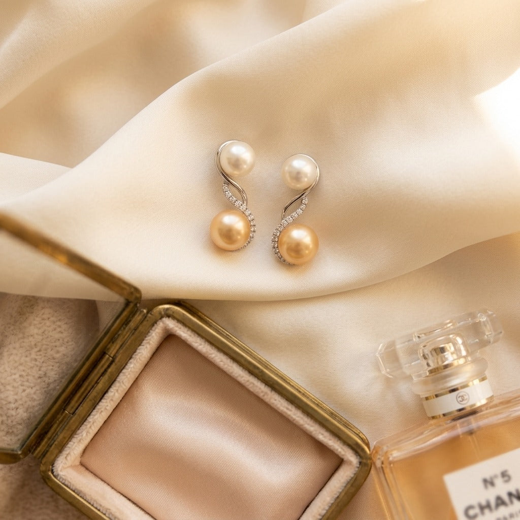 Freshwater White and Pink Pearl Swirl Diamond Earrings in 14k White Gold 1/5ctw — textile flat lay