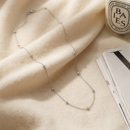 Diamonds by the Yard Round Bezel Necklace in 14k White Gold — textile flat lay