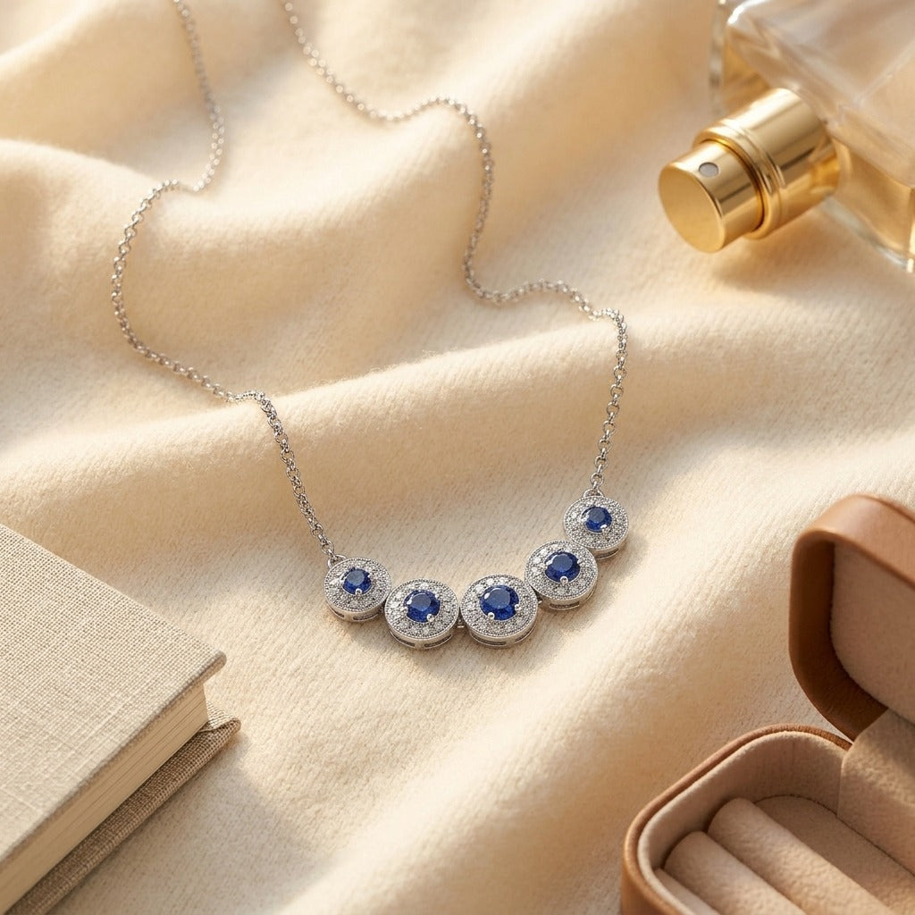 Sapphire and Diamond Graduated Curved Necklace in 14k White Gold — textile flat lay