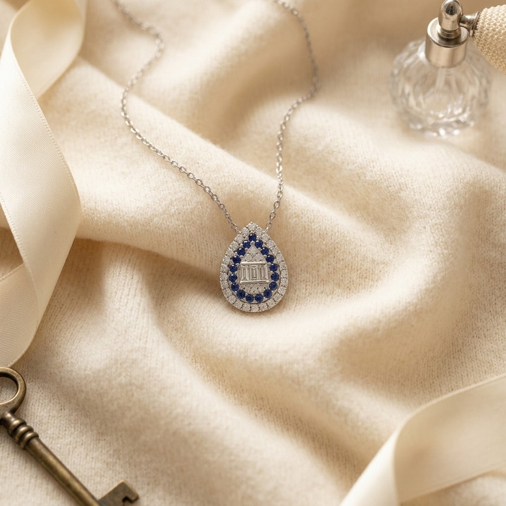 Sapphire and Diamond Pear Shape Necklace in 14k White Gold 16-18 Inch Adjustable Cable Chain — textile flat lay
