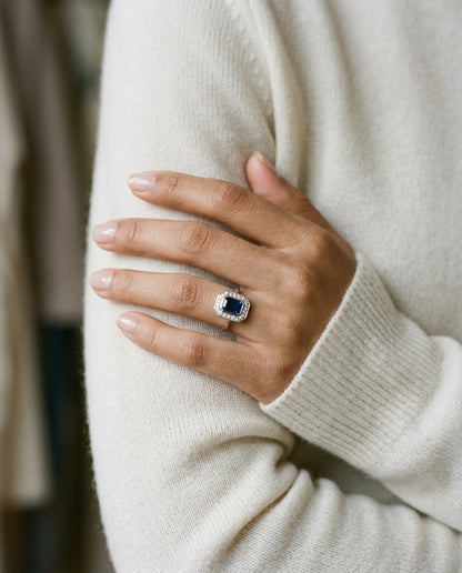 Sapphire And Diamond Bezel Emerald Cut Halo Ring In 14k White Gold — editorial close-up