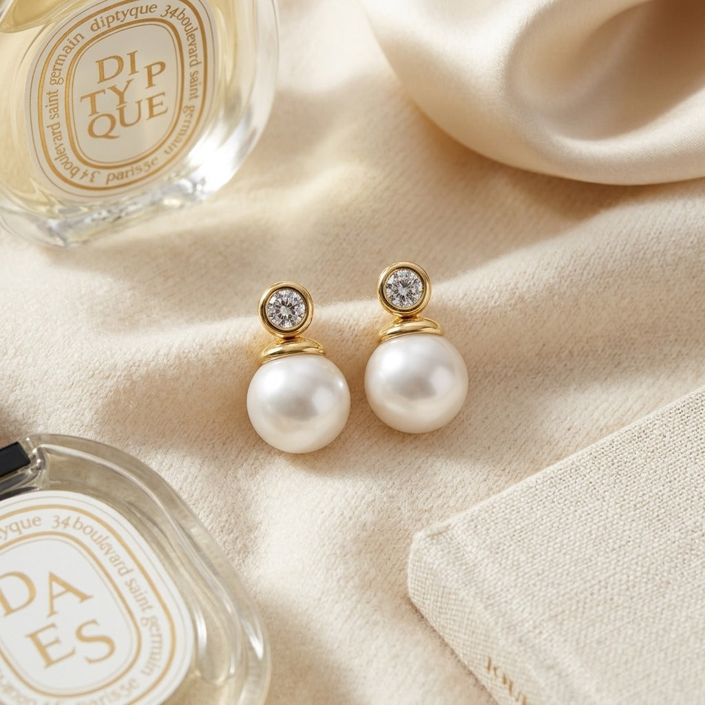 White Akoya Pearl With Diamond Earrings In 14k Yellow Gold — textile flat lay