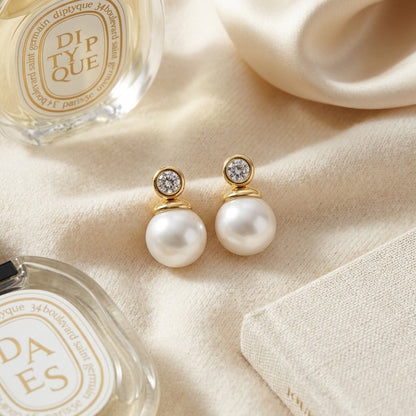 White Akoya Pearl With Diamond Earrings In 14k Yellow Gold — textile flat lay