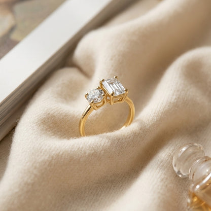 14k Yellow Gold Round and Emerald Cut Diamond Ring — textile flat lay