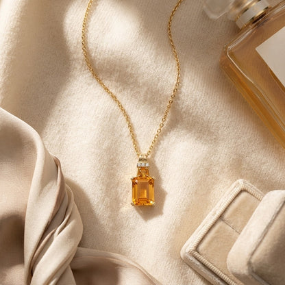 Citrine and Diamond Emerald Cut Pendant in 14k Yellow Gold (17-in Rolo Chain) — textile flat lay