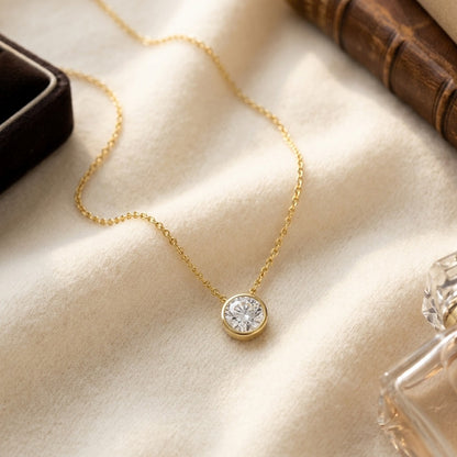 Round (Full Cut) Diamond Solitaire Pendant in a 14k Yellow Gold Bezel Slide Setting, 1ct. T.w. (J, Vs1) Gia with Paper Clip Chain — textile flat lay