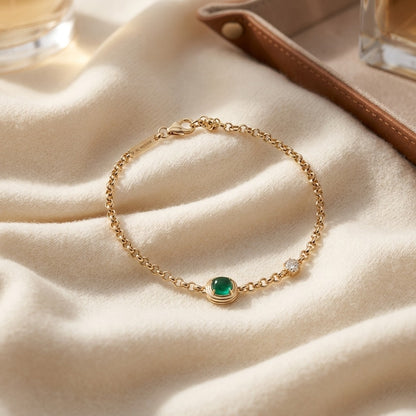 Diamond Bracelet with Created Emerald 7x5 Cushion Bracelet in 14k Yellow Gold — textile flat lay