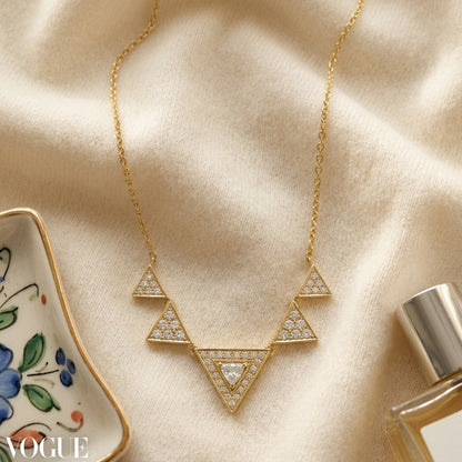Diamond Trillion Triangle Necklace In 14k Yellow Gold — textile flat lay