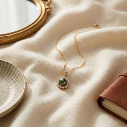 Black Tahitian Pearl And Diamond Prong Halo Pendant 14k Yellow Gold — textile flat lay