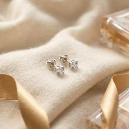 14k Yellow Gold 4-Prong Round Brilliant Diamond Stud Earrings (1.06 Ct. T.w., Vs1-Vs2 Clarity, H-I Color) — textile flat lay