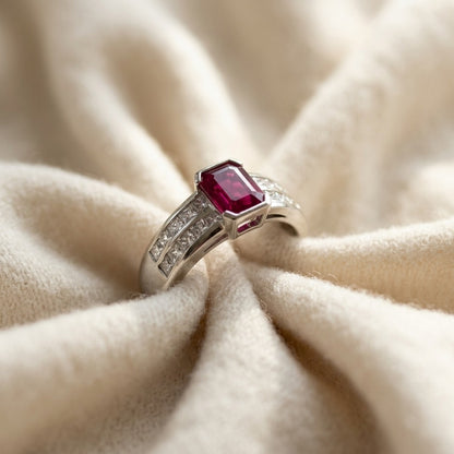 Emerald-Cut Ruby Center and Princess Cut Channel Set Diamond Shank in Platinum — textile flat lay