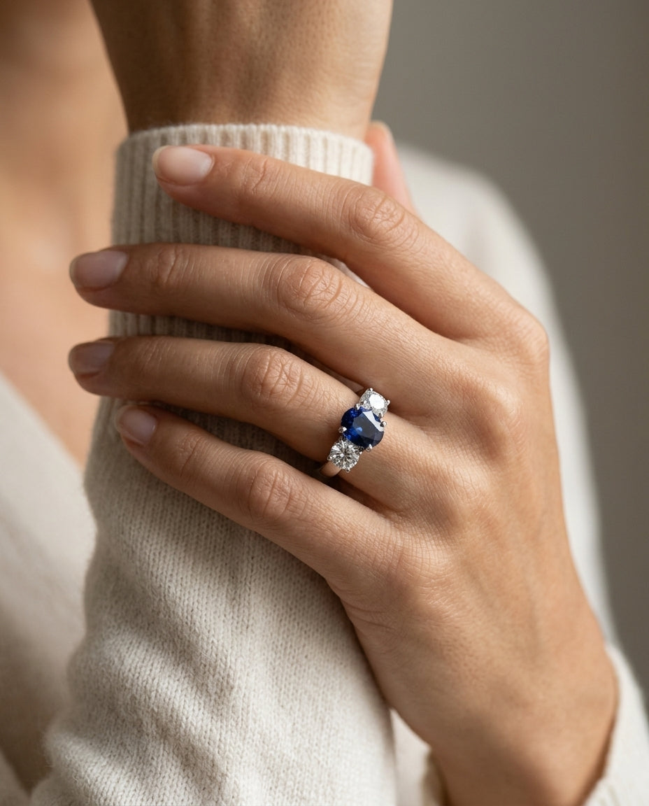 Prong Set Three Stone Round Sapphire & Diamond Engagement Ring In Platinum — editorial close-up
