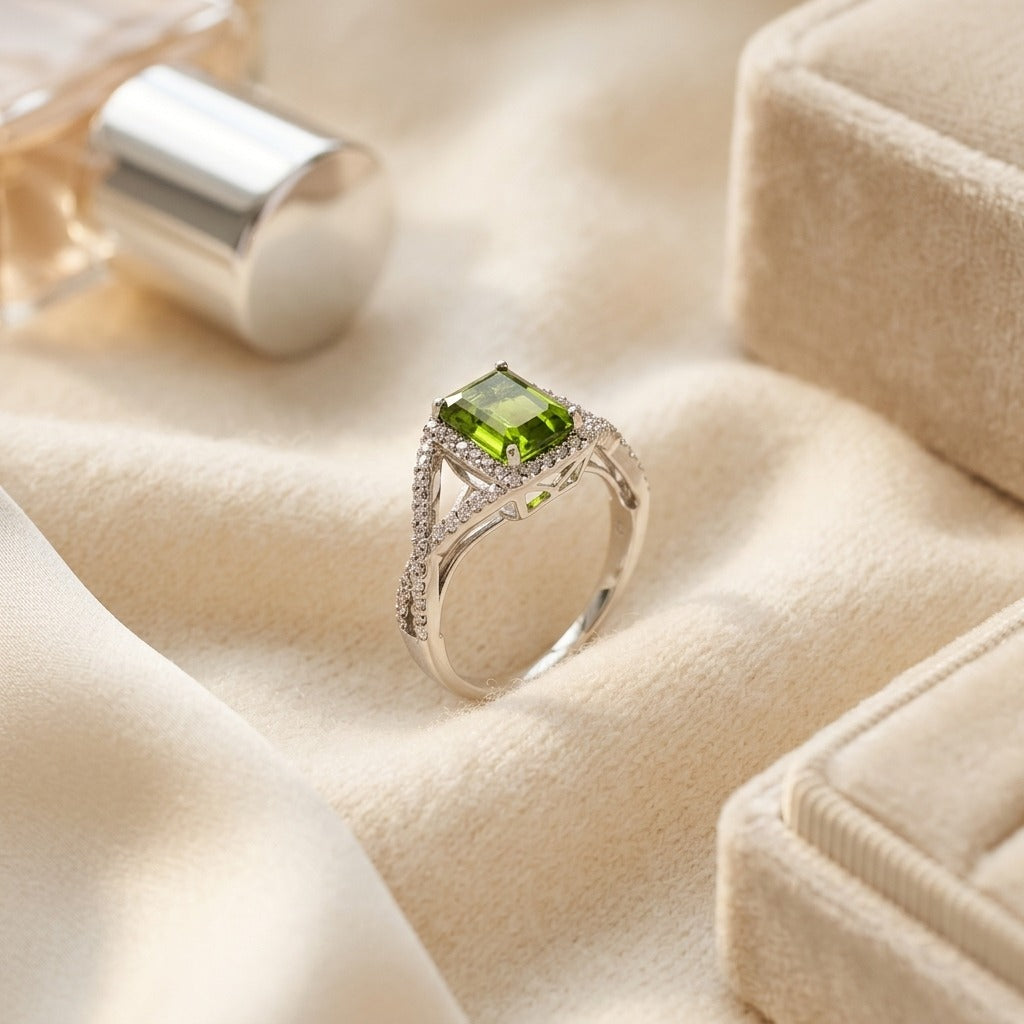 Peridot And Diamond Infinity Twist Ring In Platinum — textile flat lay