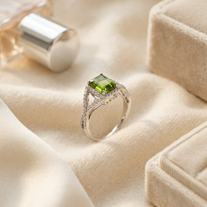 Peridot And Diamond Infinity Twist Ring In Platinum — textile flat lay